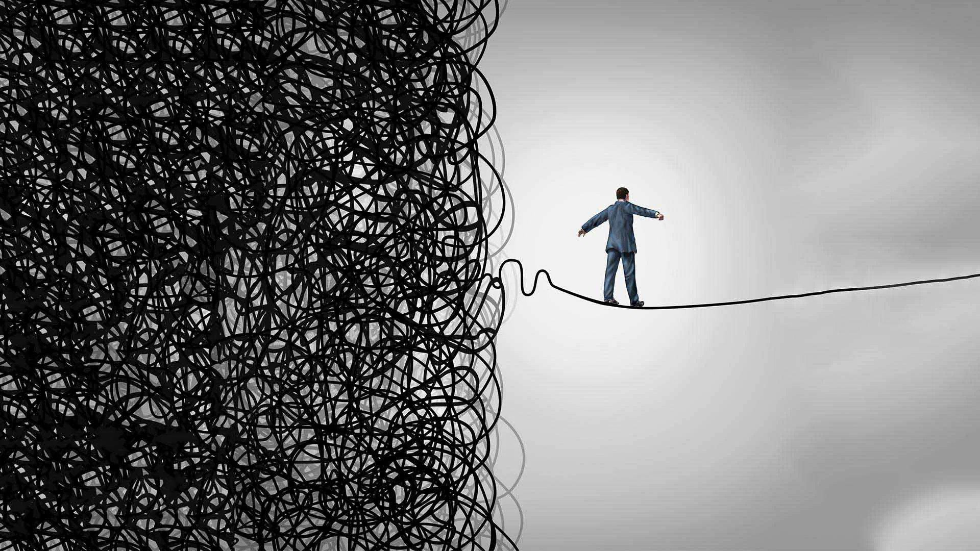 Illustrated photo shows one half of the page covered in black swirling chaotic lines, with one single line breaching the other side of the page. Atop the line, as if it was a rope, balances the figure of a person, making their way from the chaotic side to the other side on the rope, perhaps a metaphor for the individual's holistic health journey