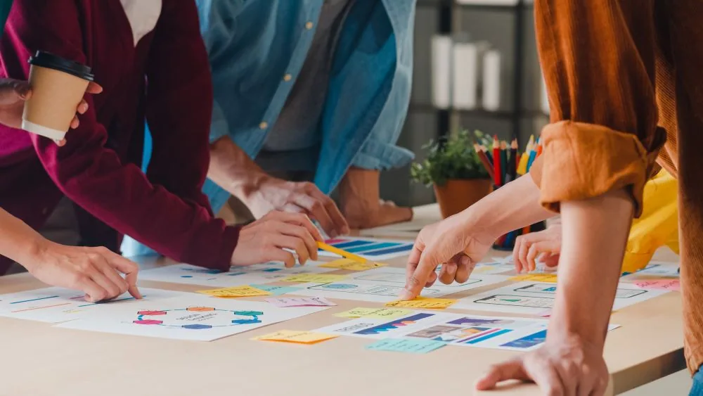Volunteers gather around a table, united by their mission and figuring out how to start a nonprofit.