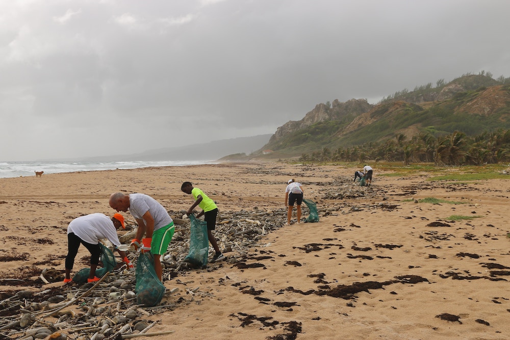 A group gives back to the local community by picking up trash and litter on the local beaches.