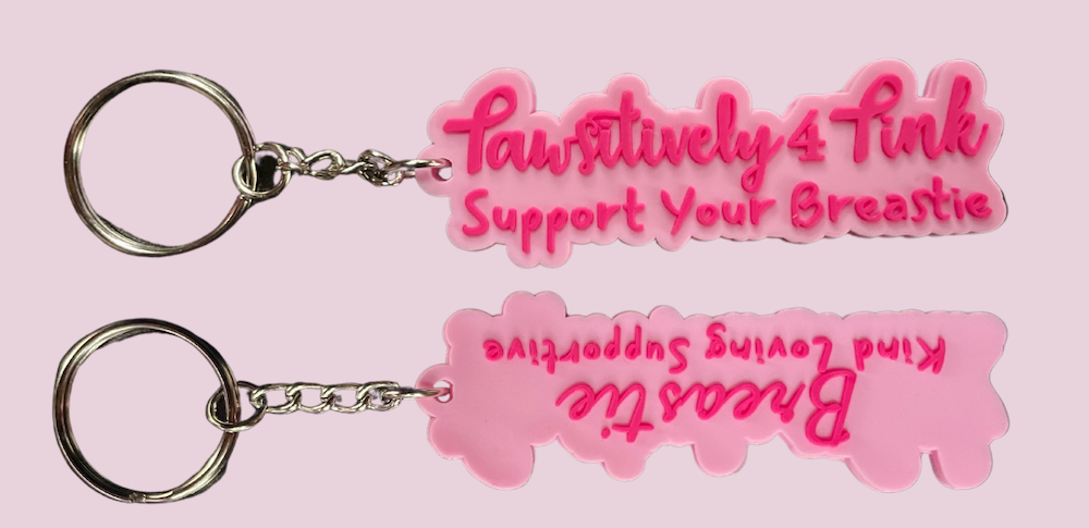 A great way to give more is to support local nonprofits and their campaigns, like with Pawsitively 4 Pink's hot pink Breasties keychain, which supports underserved women battling breast cancer.