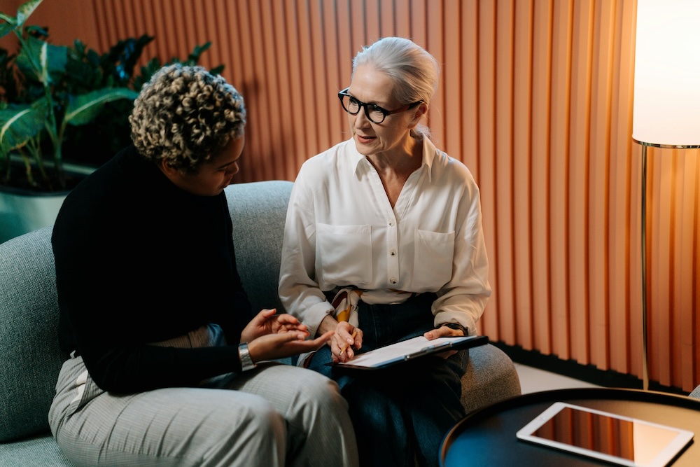 Two women discussing matching donations at the workplace.