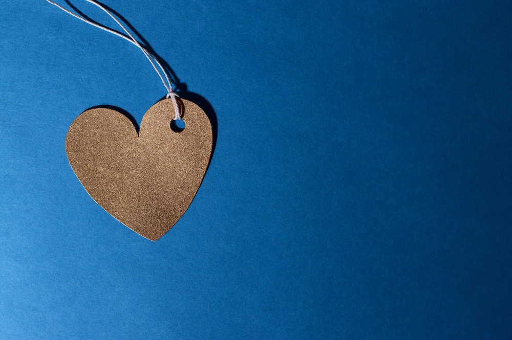 A gold heart over a blue background symbolizing love and support.