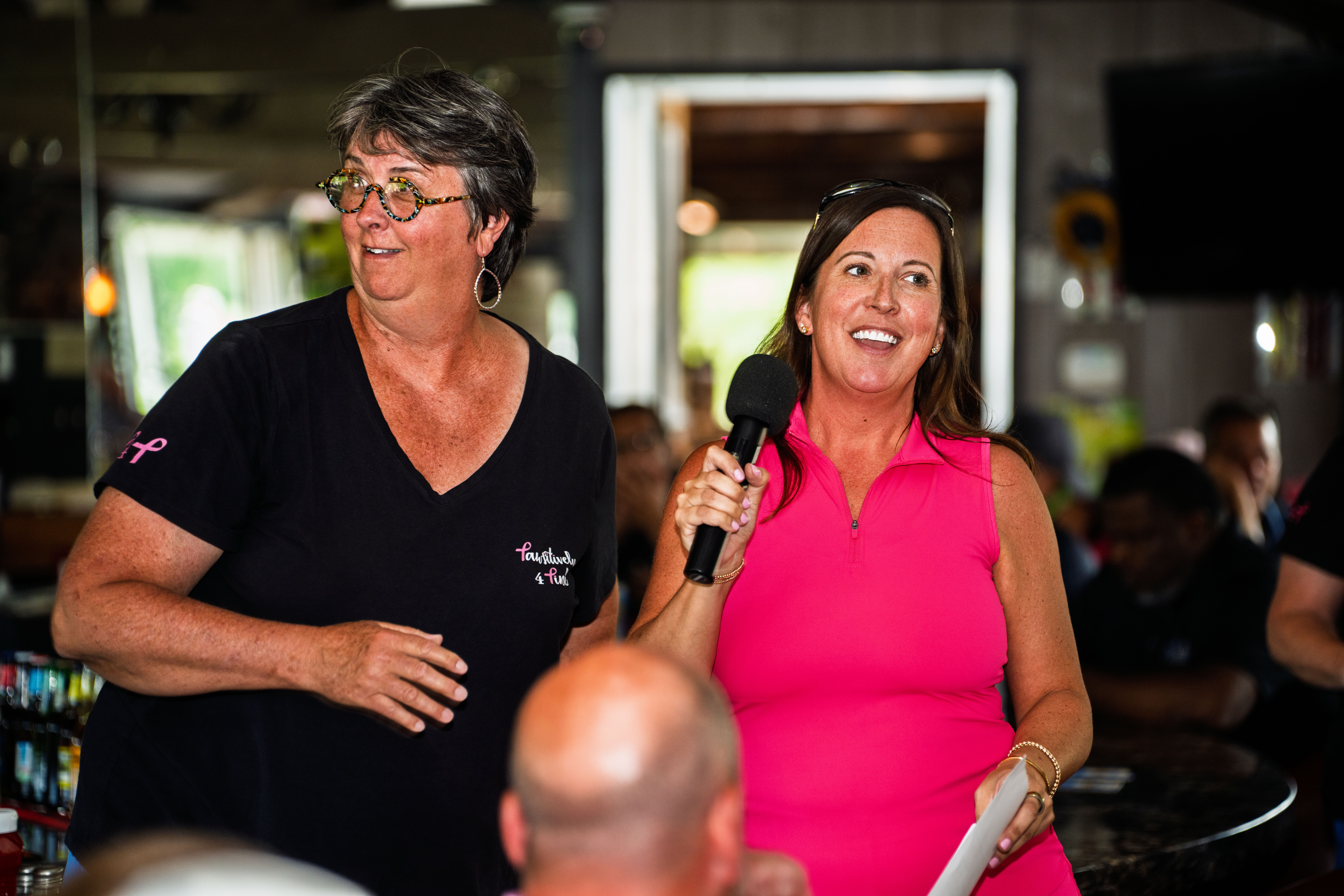 Image shows 2 women who work for P4P at an event, that was an event to raise awareness for breast cancer patients.