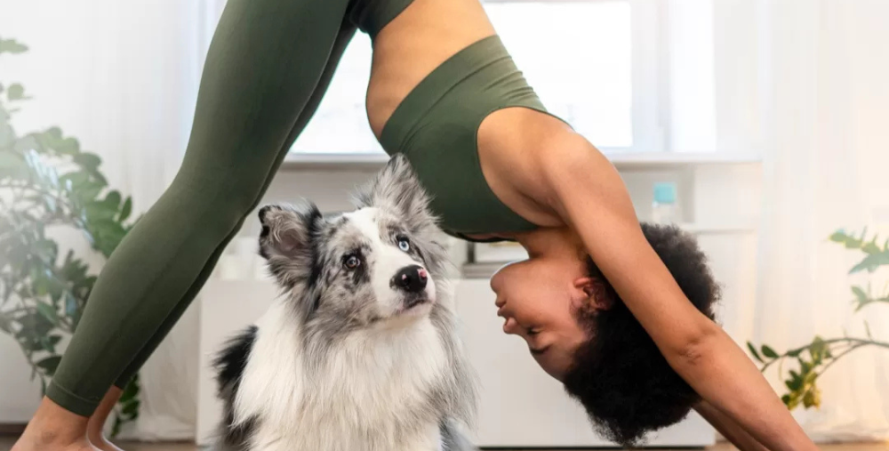 image of a women and her puppy doing yoga together
